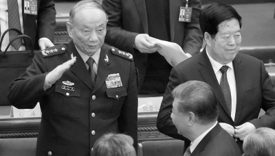 Chinese Central Military Commission Vice President Zhang Shengmin salutes Chinese President Xi Jinping.