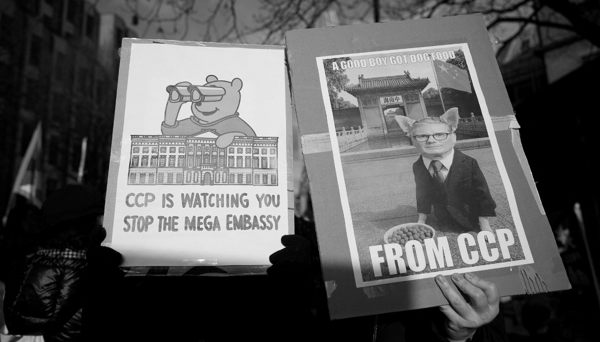 Protest placards depicting British Prime Minister Keir Starmer and Winnie-the-Pooh near the proposed site of a new Chinese mega embassy.