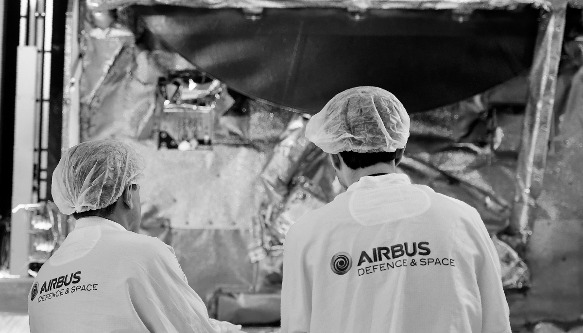 Researchers working in front of a satellite at the Airbus Defence and Space headquarters in Toulouse.