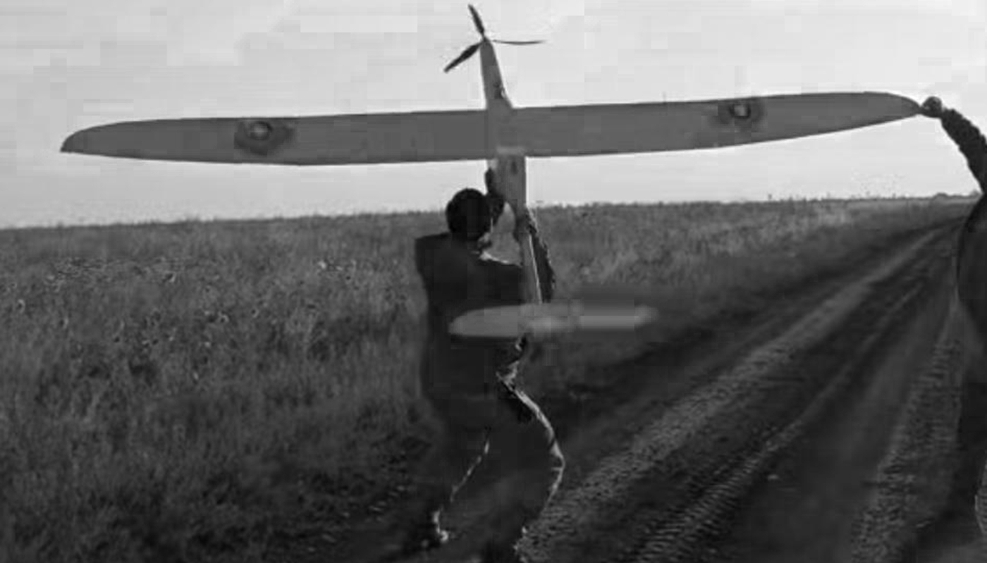 An operator from the Omega special forces unit launching a WB Electronics FlyEye tactical ISR drone.