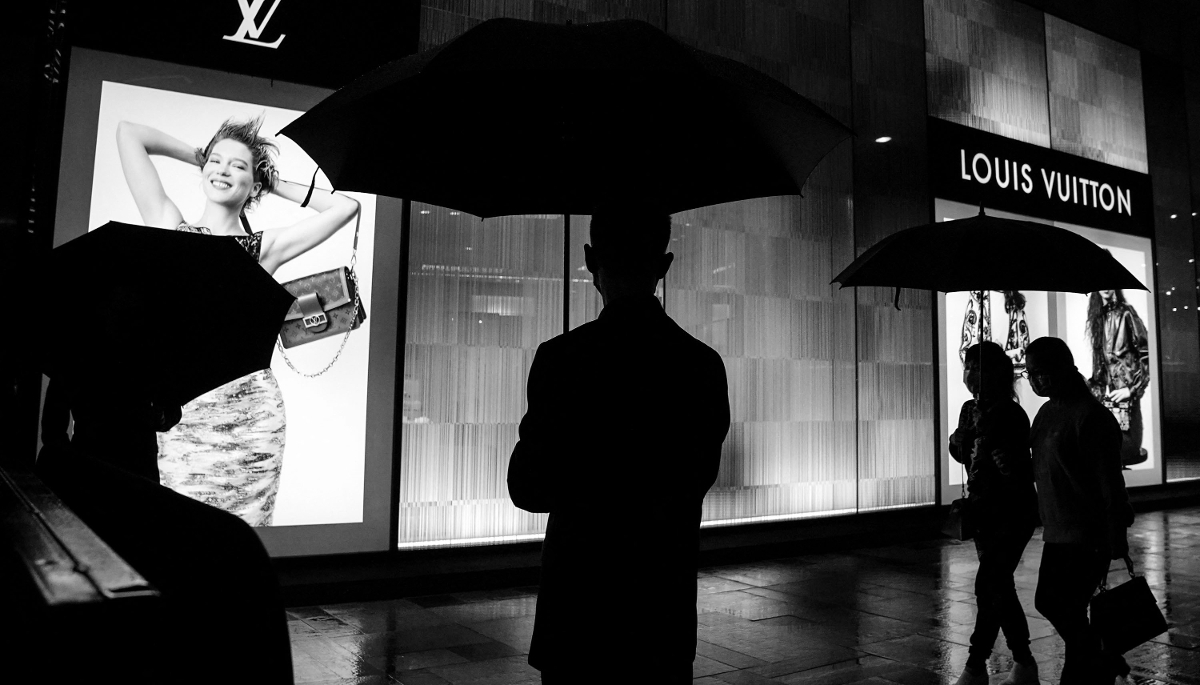 A security guard outside a Louis Vuitton shop.