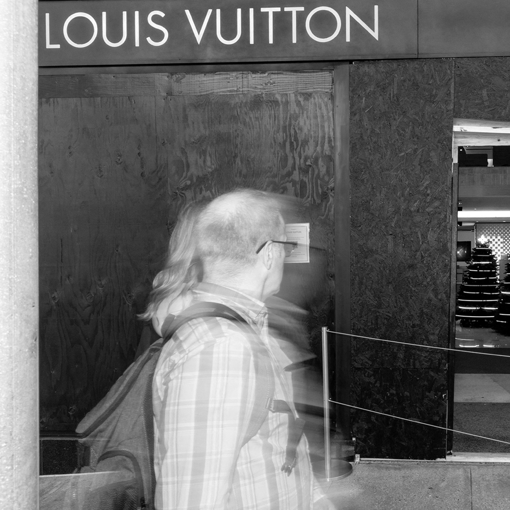 A security employee guards the entrance to a Louis Vuitton store near Union Square in San Francisco, California, on 30 November 2021.