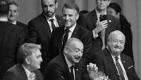 French President Emmanuel Macron walks past (L-R), Bosnia and Herzegovina's chairman of the Presidency Zeljko Komsic, Azerbaijani President Ilham Aliyev and Austrian Chancellor Christian Stocker at the European Political Community Summit in Copenhagen, on 2 October 2025.  