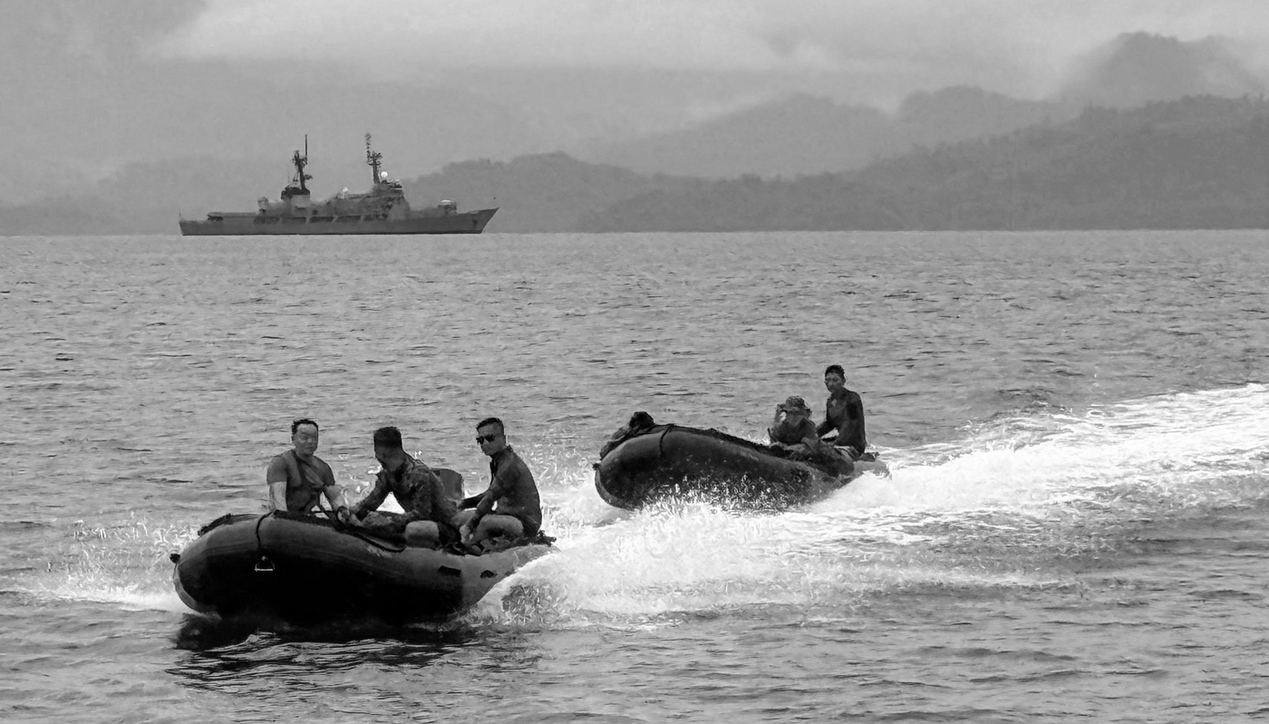 Filipino sailors in front of the offshore patrol vessel Andres Bonifacio anchored in Ulugan Bay, Puerto Princesa, west of Manila, on 8 June 2025.