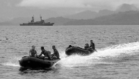 Filipino sailors in front of the offshore patrol vessel Andres Bonifacio anchored in Ulugan Bay, Puerto Princesa, west of Manila, on 8 June 2025.