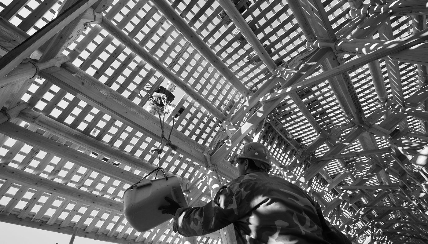 Workers restoring the roof of the wooden Wan'an Bridge in Fujian Province, China, on 29 November 2023. In December 2024, UNESCO added China's traditional practice of building wooden arch bridges to its intangible cultural heritage list.