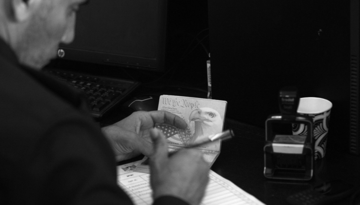 A Palestinian security officer checks an American citizen's passport at the Rafah border crossing with Egypt in the southern Gaza Strip on 2 November 2023.