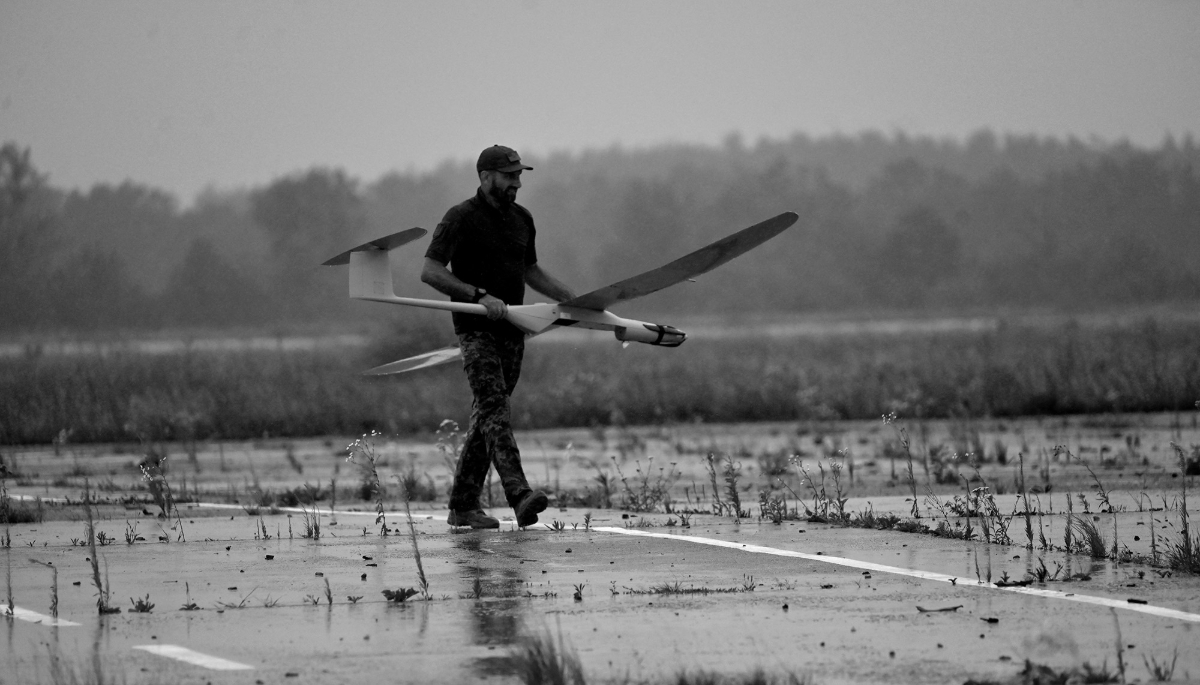 A Ukrainian officer carries a WB Electronics Polish FlyEye reconnaissance drone during test flights in the Kyiv region, in August 2022.