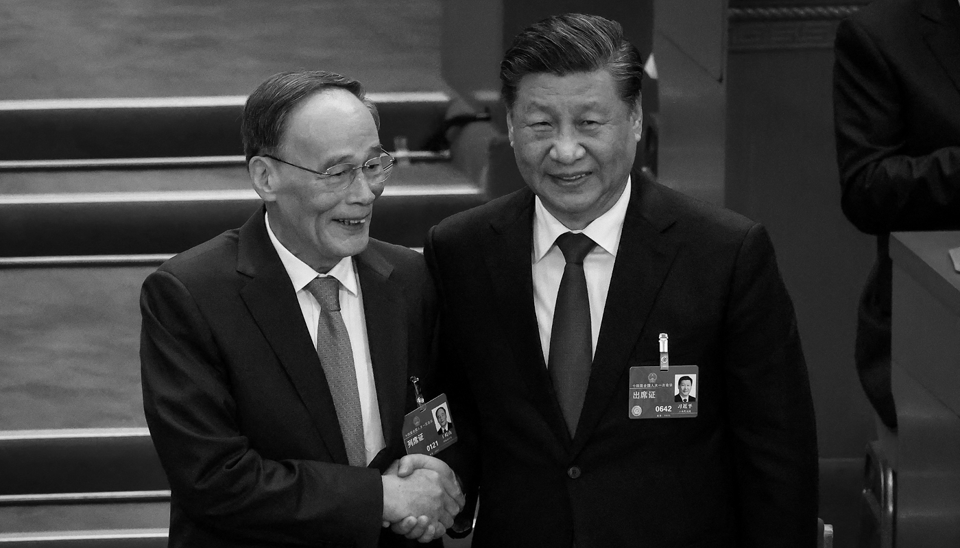 Chinese President Xi Jinping (right) shakes hands with then Vice-President Wang Qishan (left) during the third plenary session of the National People’s Congress in Beijing, China, on 10 March 2023.