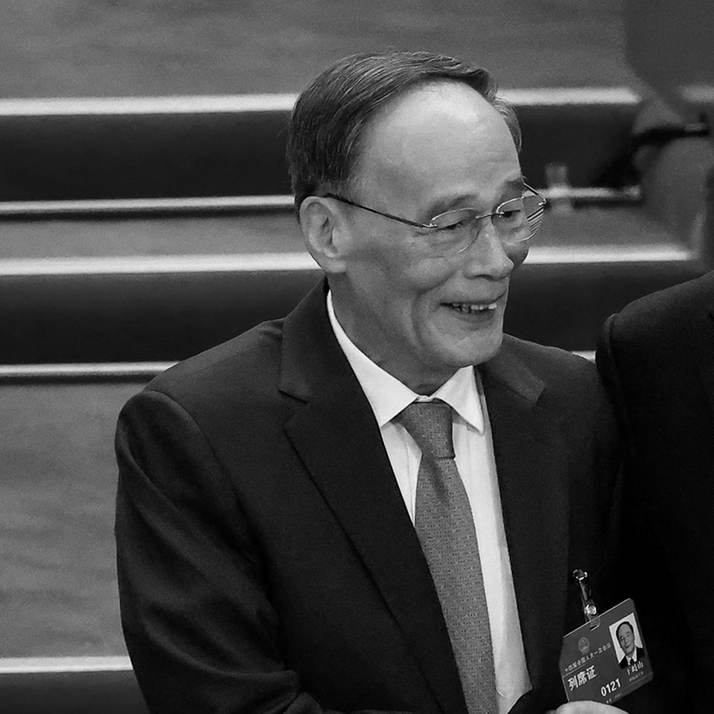 Chinese President Xi Jinping (right) shakes hands with then Vice-President Wang Qishan (left) during the third plenary session of the National People’s Congress in Beijing, China, on 10 March 2023.