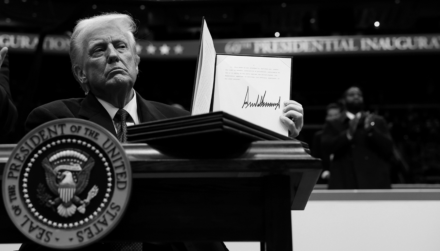 US President Donald Trump holds up an executive order after signing it during an inauguration parade on 20 January 2025 in Washington, DC.