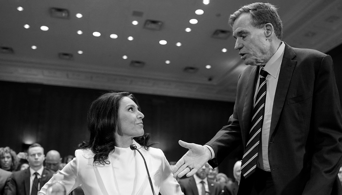 Tulsi Gabbard, President Trump's nominee for Director of National Intelligence, and US Senator Mark Warner at the Senate Intelligence Committee confirmation hearing on Capitol Hill in Washington, January 30, 2025.