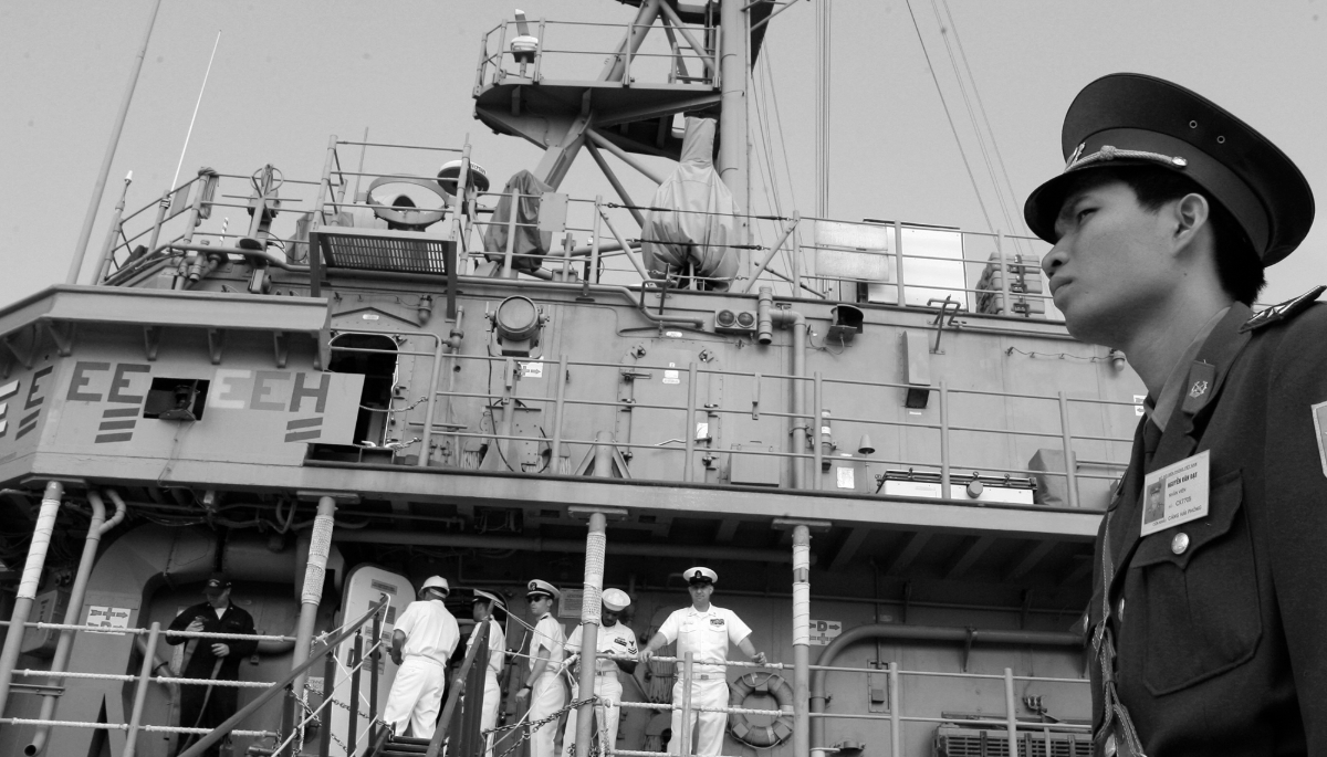 A Vietnamese coast guard with the US ship USS Patriot, in the port of Hai Phong, Vietnam.