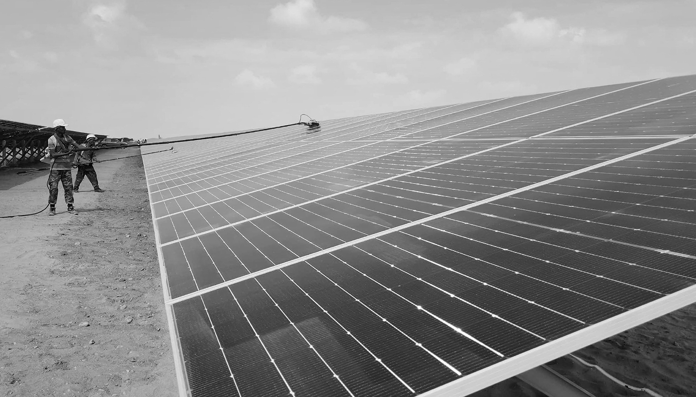 A labourer cleans solar panels during the opening ceremony for a 120MW solar power plant, supplied by the UAE, in Yemen's southern port city of Aden, on 4 March 2024.