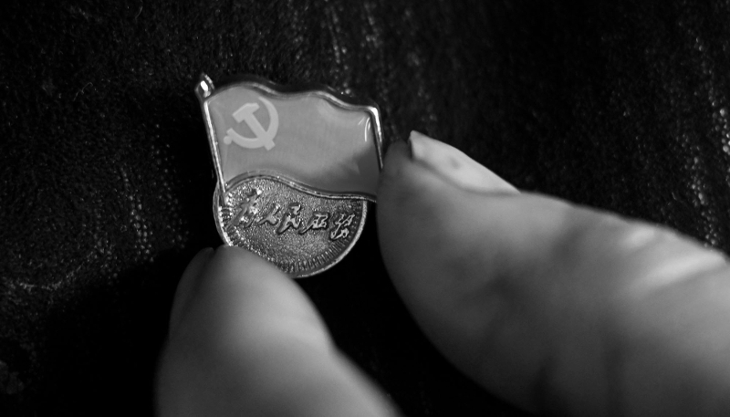 The Chinese Communist Party badge on the jacket of a member of the National People's Congress (NPC). 