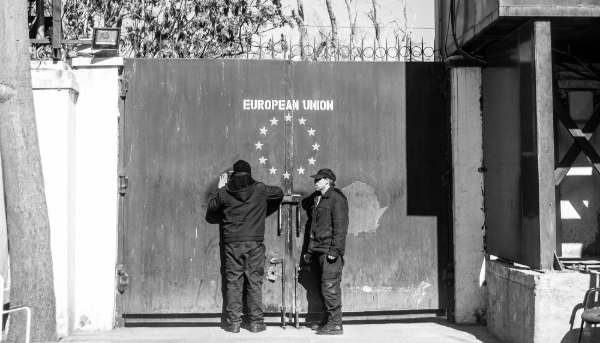 Security guards stand at an entrance gate of the European Union compound in Kabul on 8 February 2024.