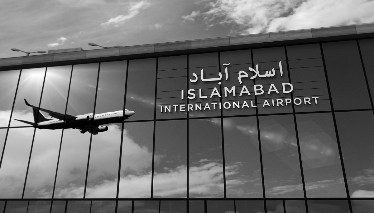 Aircraft landing at Islamabad airport (Pakistan) reflected in the terminal.