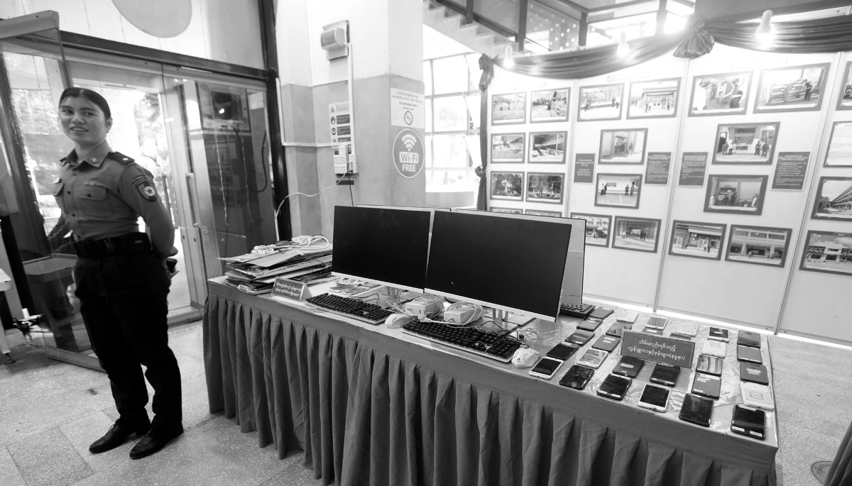 Mobile phones, computers and equipment seized from complexes used for online scams displayed at a press conference in Yangon, Myanmar, on 14 December 2025.