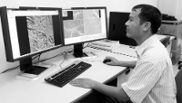 An expert works at the ground reception station of the Vietnamese National Centre for Remote Sensing in Hanoi, Vietnam, on 3 May 2013.
