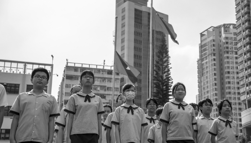 Students standing in front of the flag after the flag raising ceremony on 30 September 2023 in Hong Kong, China.