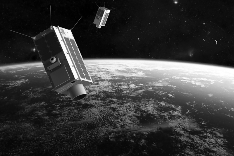 Two satellites measuring greenhouse gas emissions.