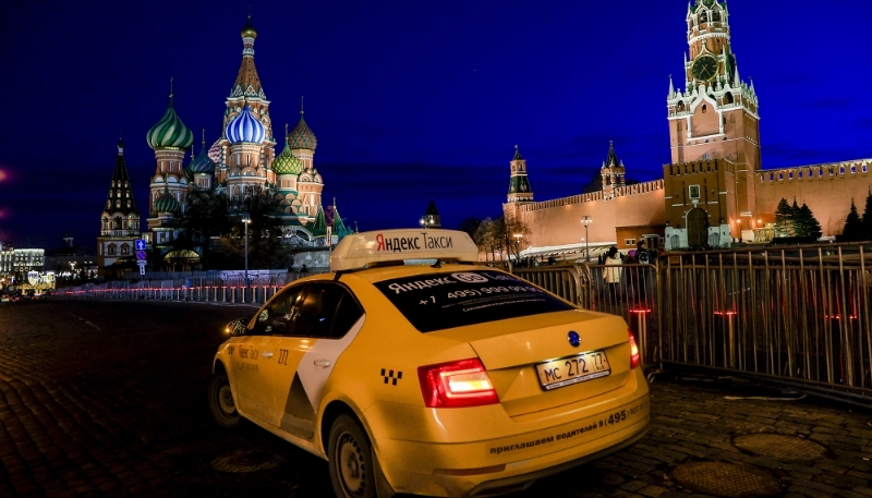 A 'Yandex Taxi' is seen in front of Saint Basil's Cathedral on Red Square in Moscow, Russia, on 24 March 2020.
