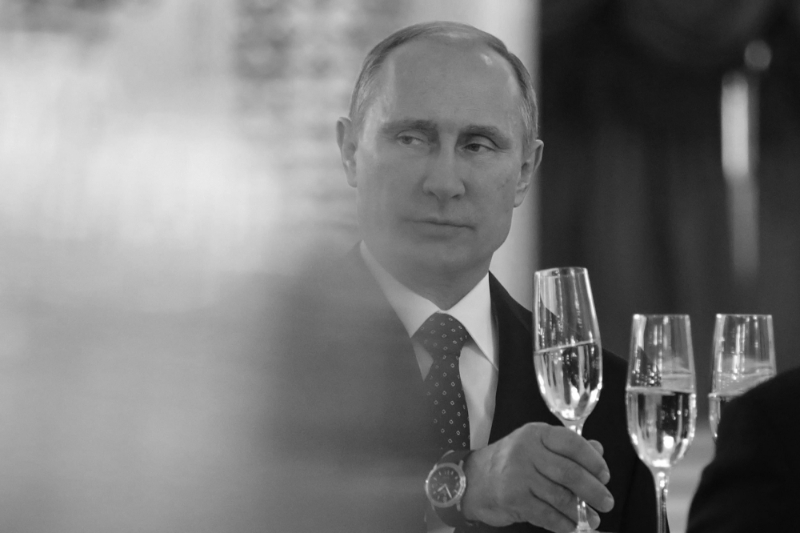 Russian President Vladimir Putin picks a glass of champagne.