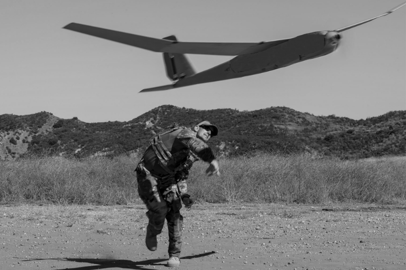 A soldier launches an AeroVironment drone.