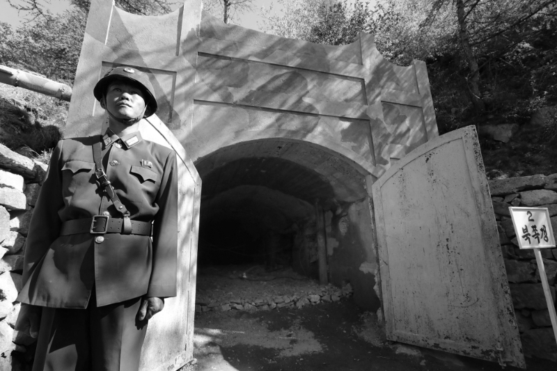 A North Korean soldier stands guard outside the entrance to one of the dismantled tunnels at the Punggye-ri site on May 24, 2018.